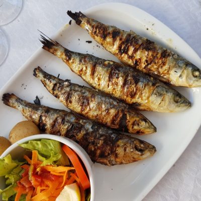 grilled fish with vegetable salad on white ceramic plate