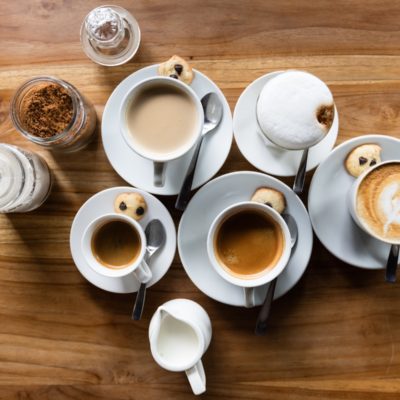 flatlay photography of five latte cups